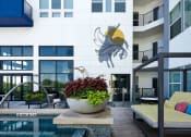 Thumbnail 8 of 24 - a large potted plant in front of a swimming pool