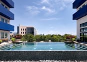 Thumbnail 2 of 24 - a swimming pool in the middle of two apartment buildings