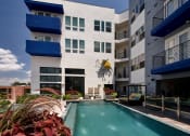 Thumbnail 4 of 24 - an apartment building with a swimming pool and a mural of a fish