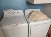 Thumbnail 10 of 39 - Two white washing machines at Woodbridge Villas Apartments, Sachse, Texas