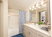 Thumbnail 8 of 39 - Bathroom with a white tub at Woodbridge Villas Apartments, Sachse, TX