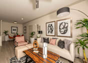 Thumbnail 9 of 39 - Living room with a white couch at Woodbridge Villas Apartments, Texas, 75048