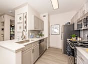 Thumbnail 6 of 39 - Kitchen with stainless steel appliances at Woodbridge Villas Apartments, Sachse, TX, 75048