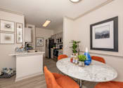 Thumbnail 7 of 39 - Kitchen with a white island at Woodbridge Villas Apartments, Sachse