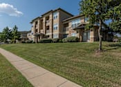 Thumbnail 37 of 39 - Buildings with a sidewalk at Woodbridge Villas Apartments, Texas, 75048