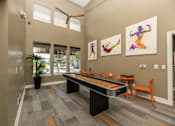 Thumbnail 21 of 39 - Clubhouse with fitness-themed wall art at Woodbridge Villas Apartments, Texas