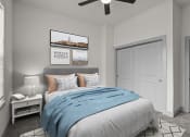 Thumbnail 13 of 34 - a bedroom with a bed and a ceiling fan