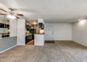 Thumbnail 14 of 36 - an empty living room and kitchen with a ceiling fan