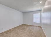 Thumbnail 18 of 36 - an empty room with carpet and a window