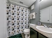 Thumbnail 20 of 36 - a bathroom with a shower and a sink and a toilet