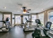 Thumbnail 23 of 36 - the gym has plenty of cardio equipment and a ceiling fan