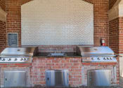 Thumbnail 30 of 54 - a kitchen with two stoves and three stainless steel stoves