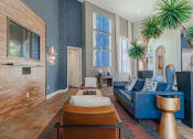 Thumbnail 19 of 54 - a living room with blue walls and a brick fireplace