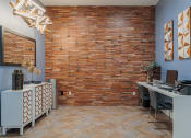 Thumbnail 47 of 54 - an office with a brick wall and wood flooring
