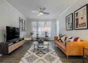 Thumbnail 7 of 54 - a living room with a ceiling fan and a large window