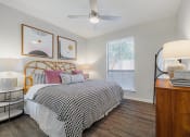 Thumbnail 8 of 54 - a bedroom with a large bed and a ceiling fan