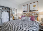 Thumbnail 9 of 54 - a bedroom with a bed with a black and white comforter and colorful pillows