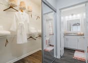 Thumbnail 13 of 54 - a white robe hangs on a hangar in a white bathroom