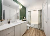Thumbnail 10 of 66 - a bathroom with a white sink and a toilet and a shower
