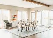 Thumbnail 25 of 34 - a dining room with a table and chairs and a rug