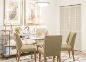 Thumbnail 4 of 34 - a dining room with a table and chairs