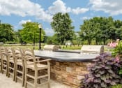 Thumbnail 3 of 25 - a patio with chairs and a stone wall and a pool