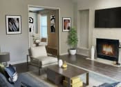 Thumbnail 14 of 22 - a living room with a fireplace and a couch