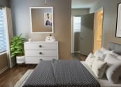 Thumbnail 12 of 22 - a bedroom with a bed and a dresser and a mirror