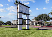 Thumbnail 20 of 20 - A sign for Azure Apartment Homes stands in a grassy area.