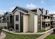Thumbnail 3 of 23 - A row of houses with a sidewalk in front.