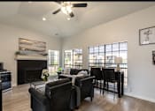 Thumbnail 7 of 23 - A living room with a fireplace and a ceiling fan.