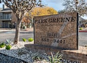 Thumbnail 28 of 28 - A sign for Park Greene Apartment Homes is displayed in front of a tree.