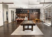 Thumbnail 9 of 21 - A pool table is in the middle of a room with a bar in the background.