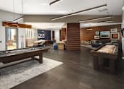 Thumbnail 10 of 21 - A room with a pool table and a billiard table.
