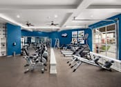 Thumbnail 15 of 21 - A gym with a variety of exercise equipment including treadmills, stationary bikes, and weight machines.