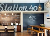 Thumbnail 13 of 21 - A restaurant named Station 40 has a welcoming interior with wooden furniture and a chalkboard wall.