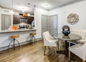 Thumbnail 4 of 24 - A kitchen with a white table and chairs.