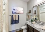 Thumbnail 8 of 24 - A bathroom with a toilet, sink, and a painting of a horse.