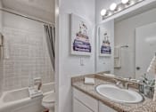 Thumbnail 11 of 17 - Bathroom with granite counters and tile shower with bathtub
