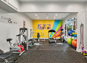 Thumbnail 27 of 45 - A gym with a variety of equipment including treadmills, weights, and exercise machines.