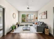 Thumbnail 7 of 19 - the living room of an apartment with a couch and a coffee table