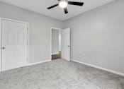 Thumbnail 37 of 45 - A room with a ceiling fan and two doors.