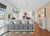 Thumbnail 18 of 19 - A reception area with a black and white patterned bar.