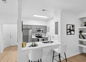 Thumbnail 21 of 45 - A modern kitchen with a white countertop and a sink.
