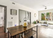 Thumbnail 15 of 19 - the dining room and living room of a house with a table and a large window