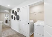 Thumbnail 20 of 37 - A laundry room with a washer and dryer.