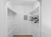 Thumbnail 29 of 45 - A white closet with two shelves and a coat hanger.