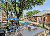 Thumbnail 31 of 38 - A backyard with a pool and a table with chairs.