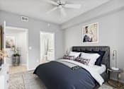 Thumbnail 29 of 33 - a bedroom with a bed and a ceiling fan