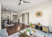 Thumbnail 8 of 19 - a living room with a table and a ceiling fan